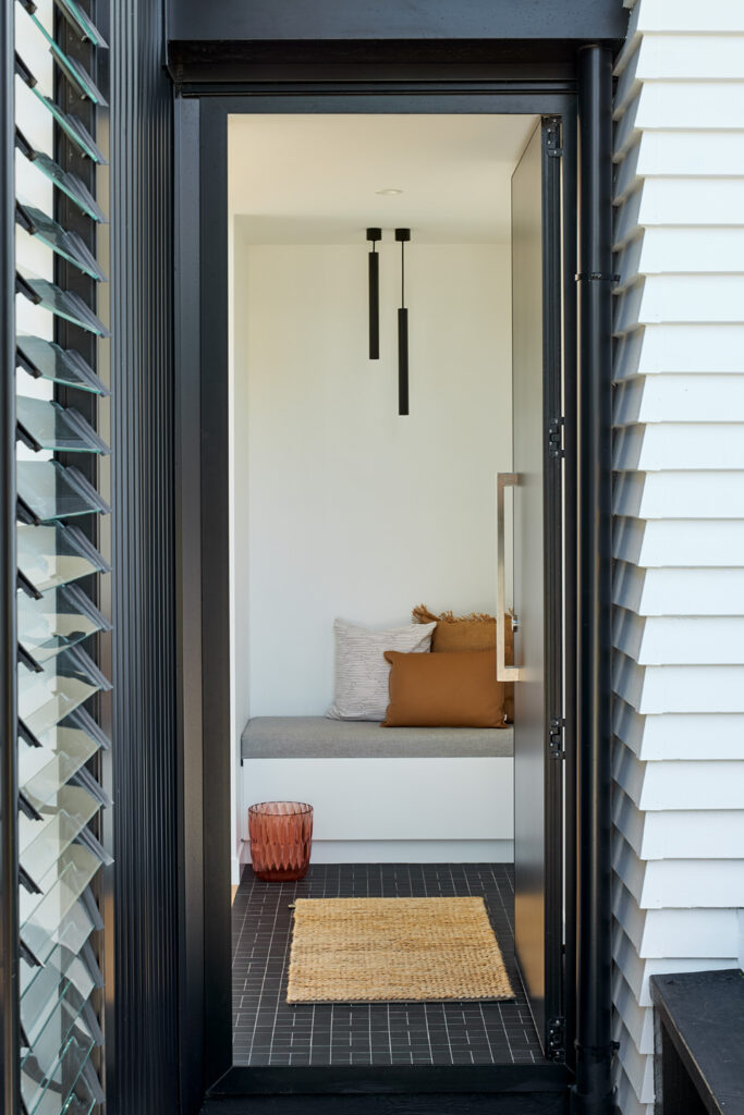 Between the two pavilions, a new entry with a built-in seat, Meadowbank renovation
