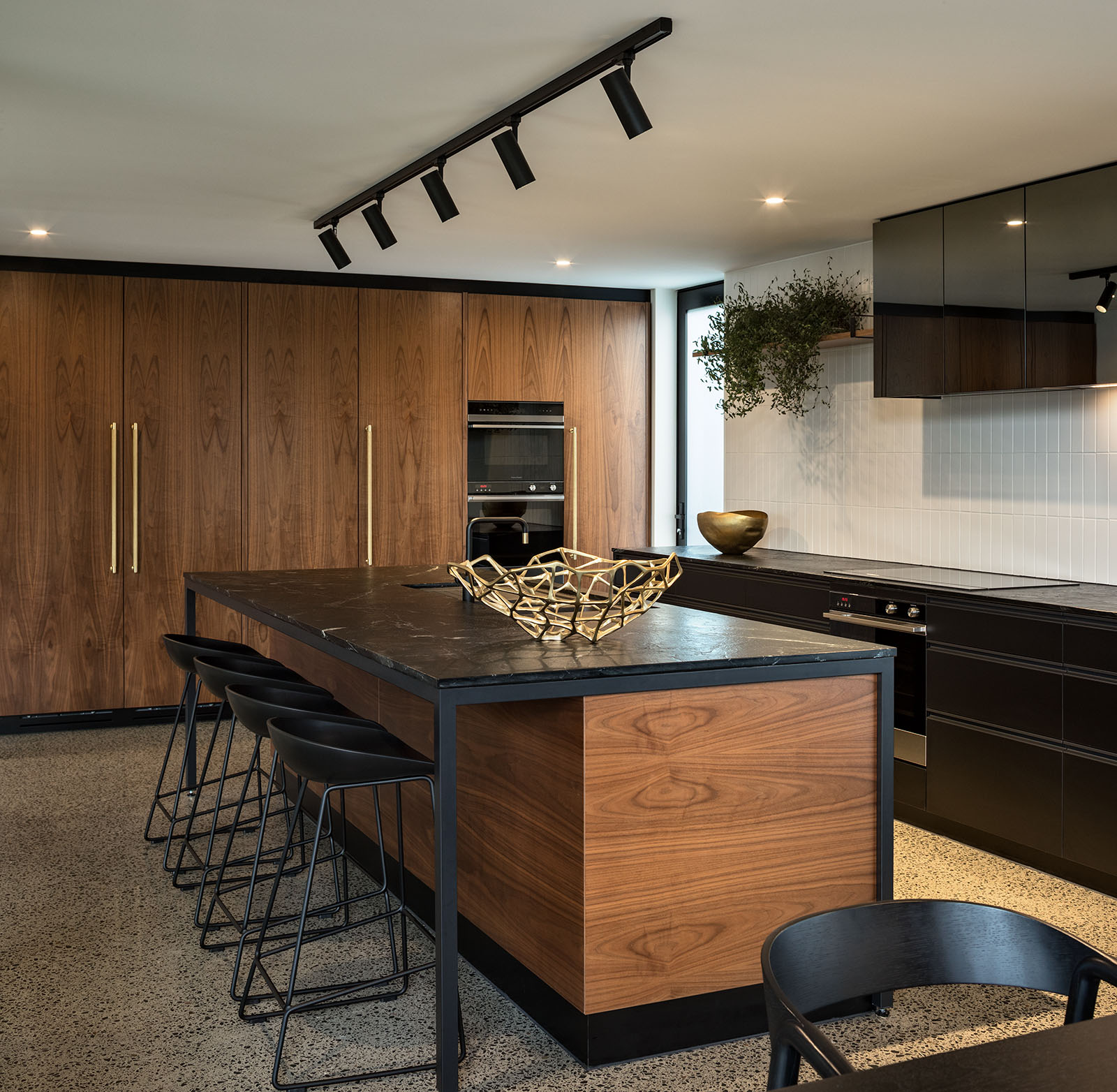 Walnut, black granite and brass details in kitchen, new build