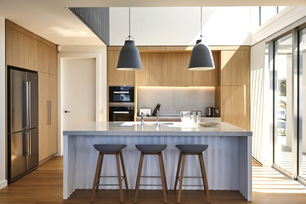 Double-height kitchen with origami island bench, Opito Bay