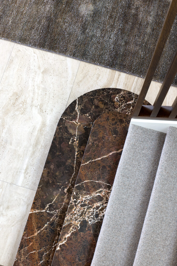 Interior stair detail showing marble staircase landing and easy use carpet stair