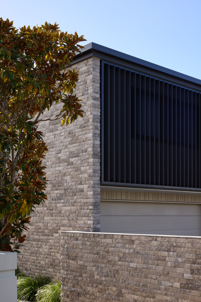 Marble cladding and louvres to street for privacy, new house in Mission Bay