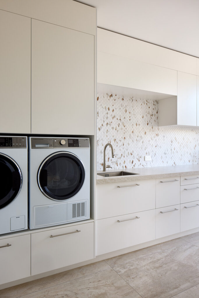 generous full laundry with appliances raised up for easy access