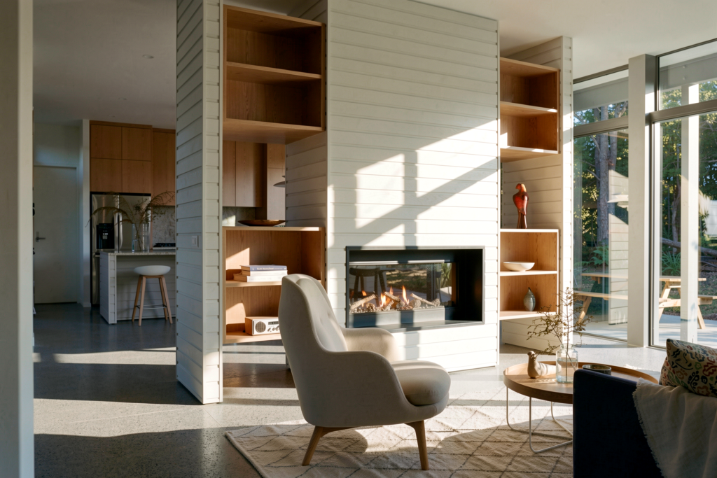 Open-plan living area with double-sided fireplace, Waipu lifestyle home