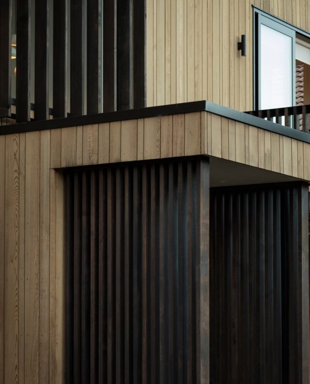 Exterior slatted screens frame the entrance of this St Heliers home will mimicing the irregular timber cladding.